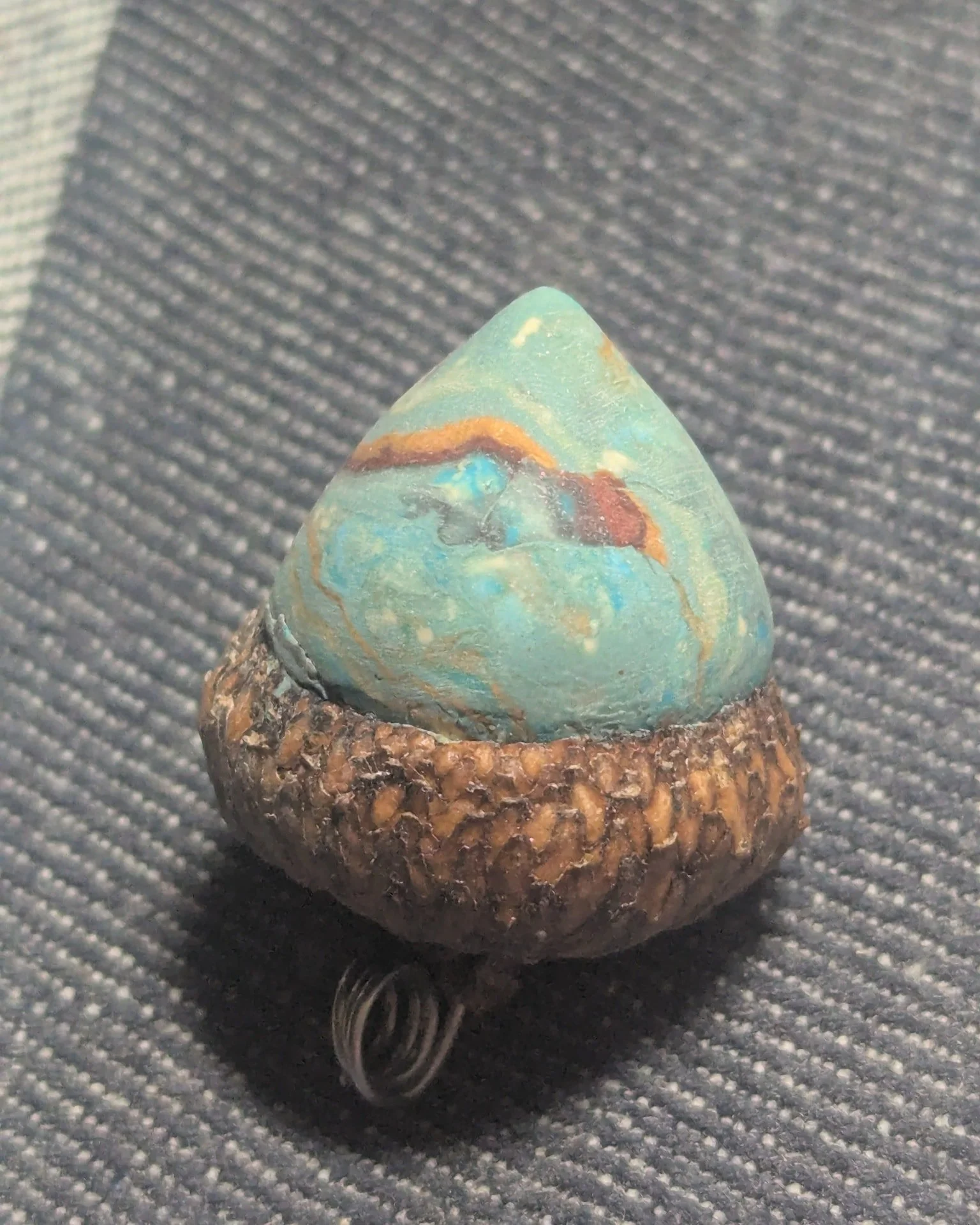 Polishing polymer acorns 
They start out dull and rough. 
5 minutes later with 1800 grit sandpaper &amp; water then buffing on a towel and finish with rough blue jeans.