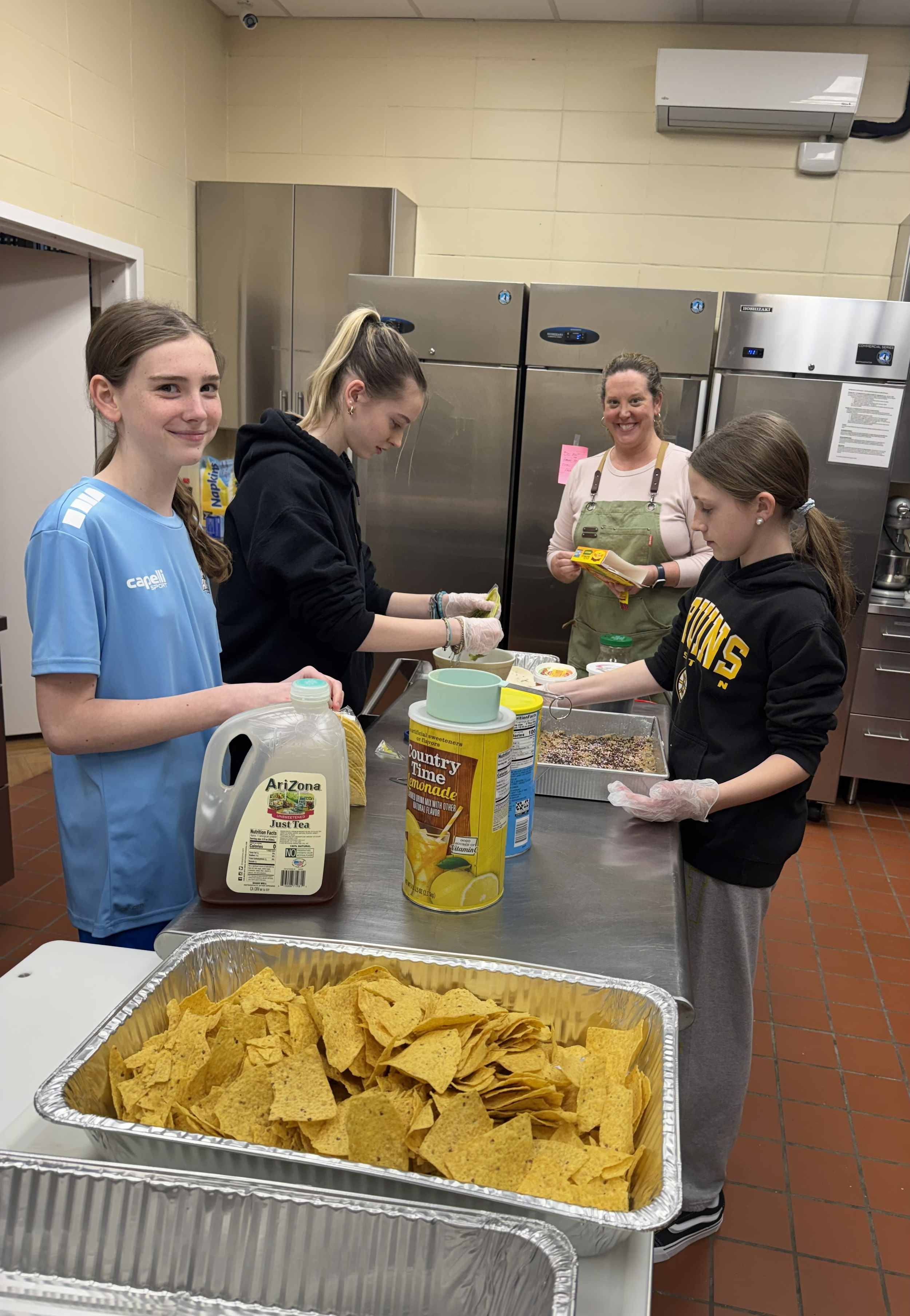 Winter Relief Youth Making Dinner 2026 Taco Bar.png