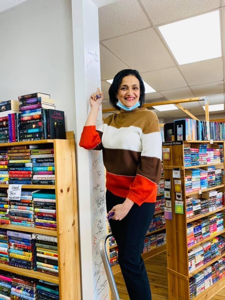 Veena-signing-author-wall-at-Atlanta-bookstore.jpg