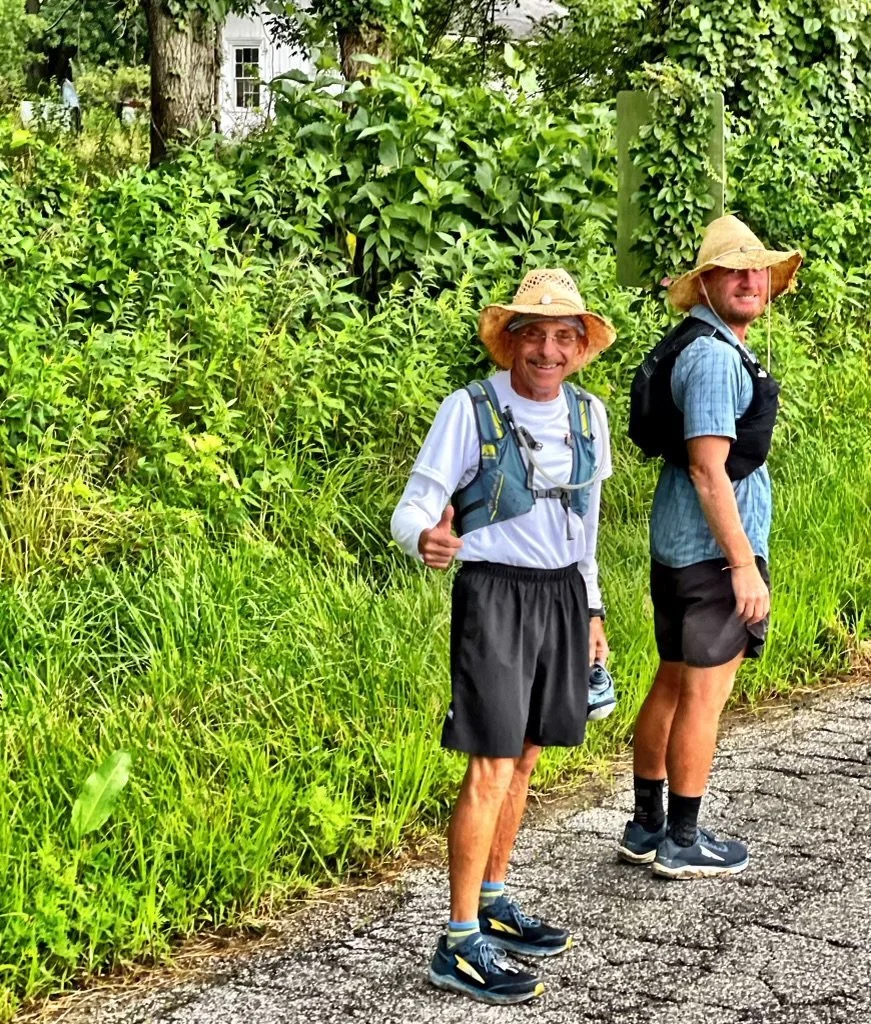Bob Becker and David Green standing on a rural road during David's run across America, July 2021.
