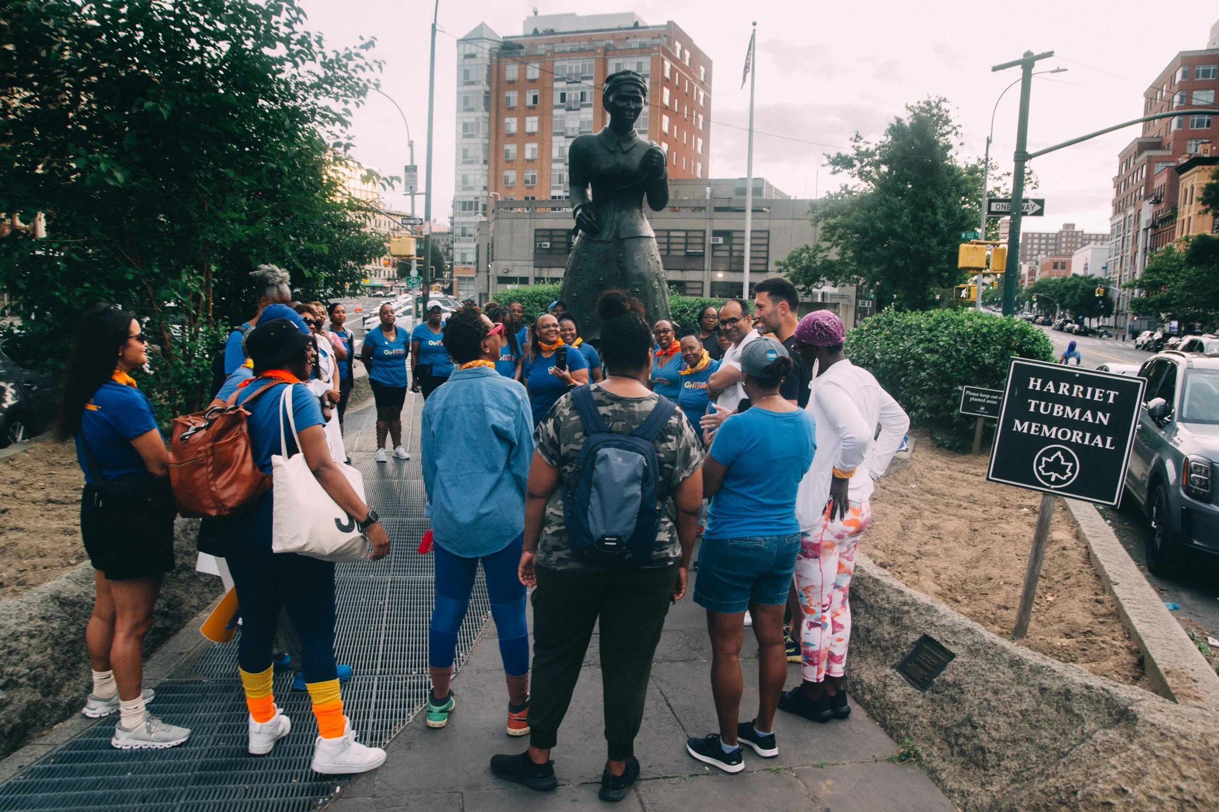 Pictured: Trekkers gathered at sunrise at the Harriet Tubman Memorial in Harlem.