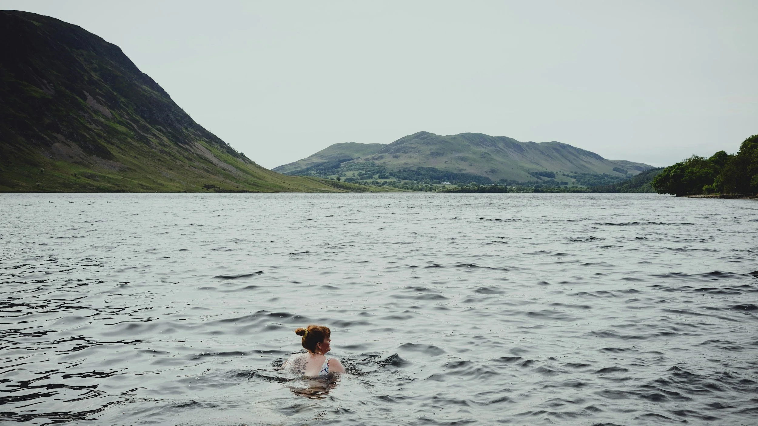 Lady immersed in the ocean during a wild swim in Wales