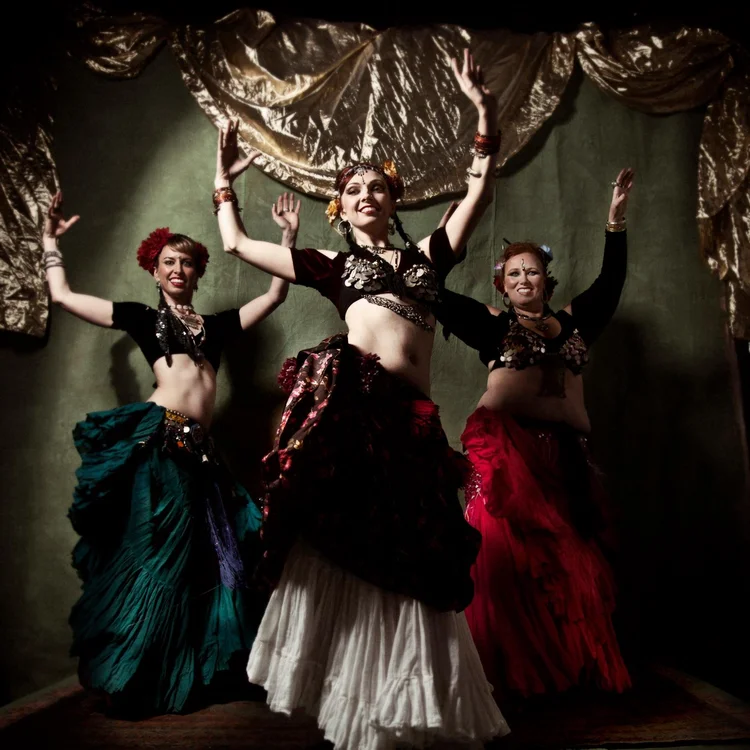 Three dancers in colorful costumes