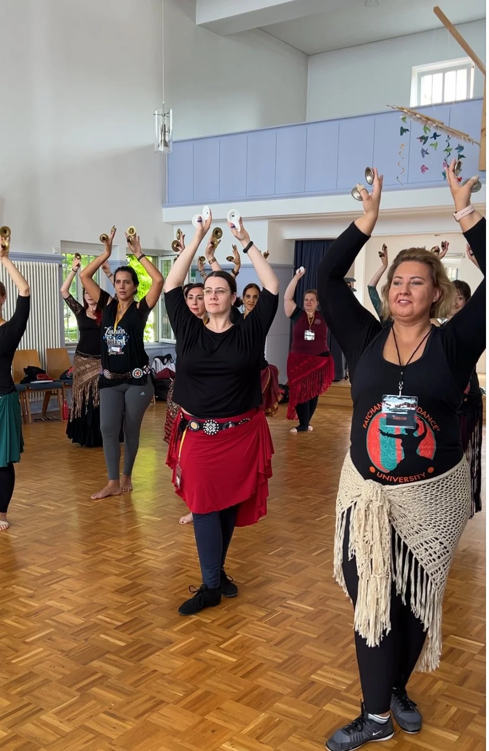 Dancers with zils raised overhead