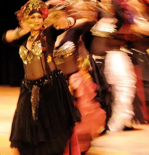 A dancer in a colorful costume performing