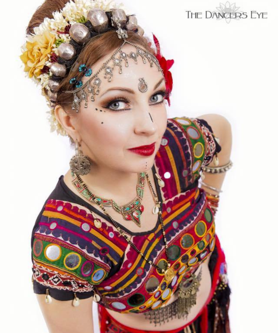 Megha in full FCBD®Style costume with a flower headdress, looking up at the camera
