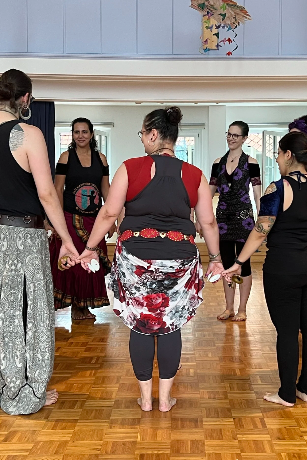 FCBD® Style dancers in a circle playing zils