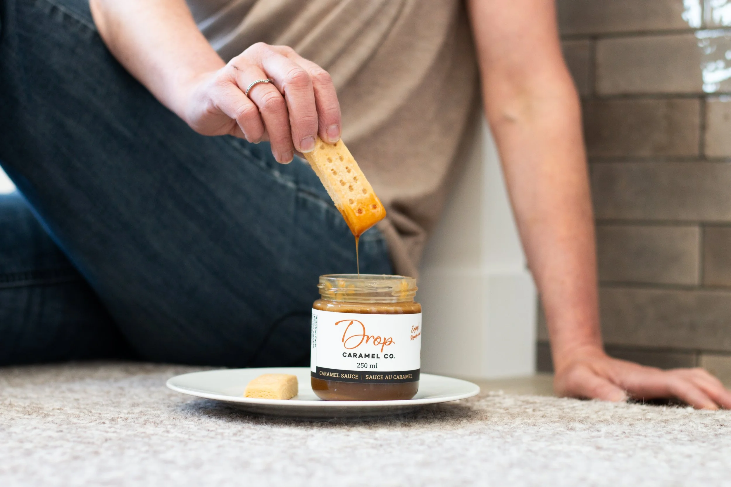 dipping cookie in caramel sauce