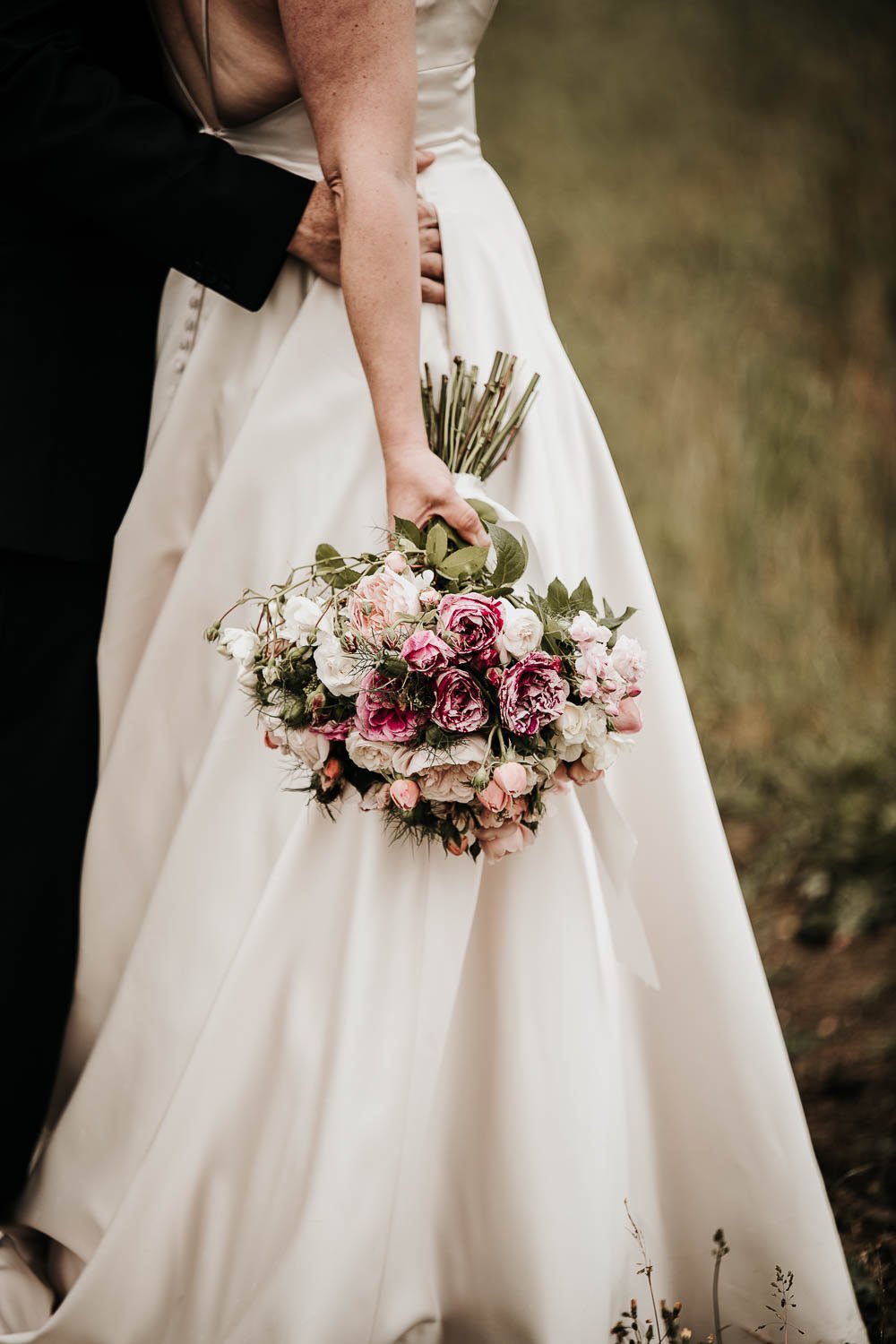 Bride holding bouquet by her side