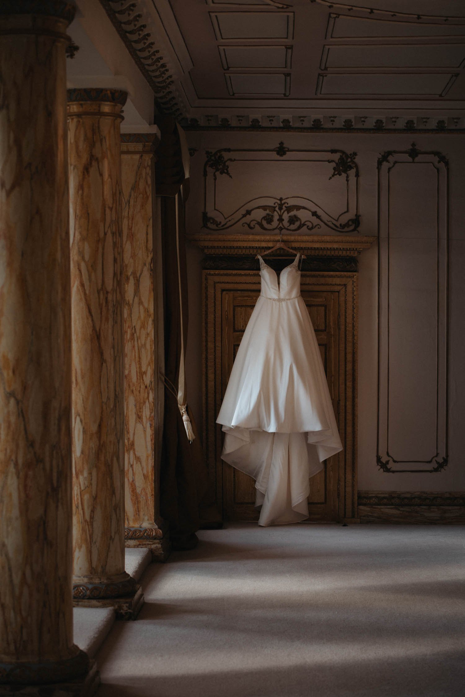 Stella York wedding dress hanging in bridal suite at Gosfield Hall Essex