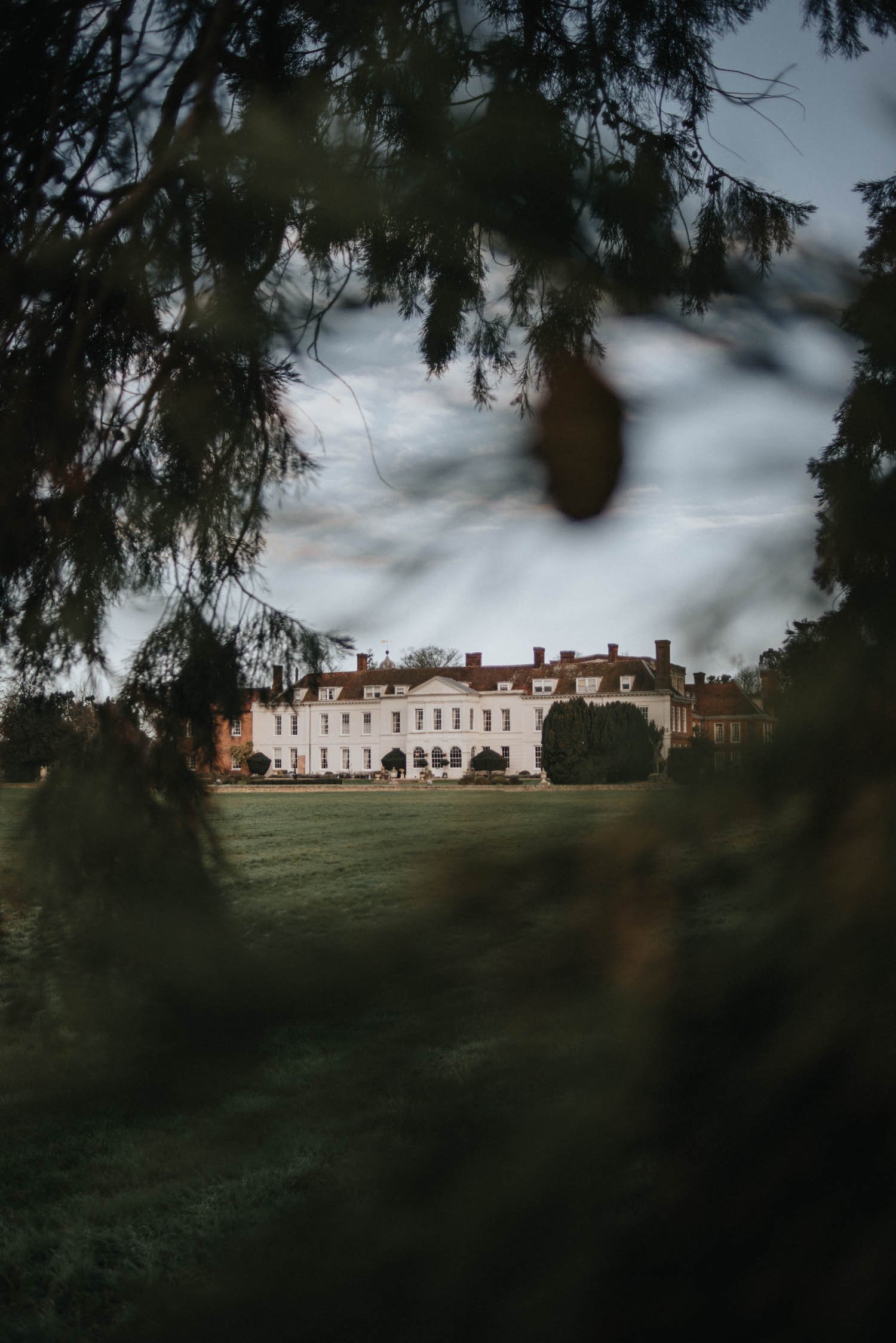 Looking at Gosfield Hall through winter trees