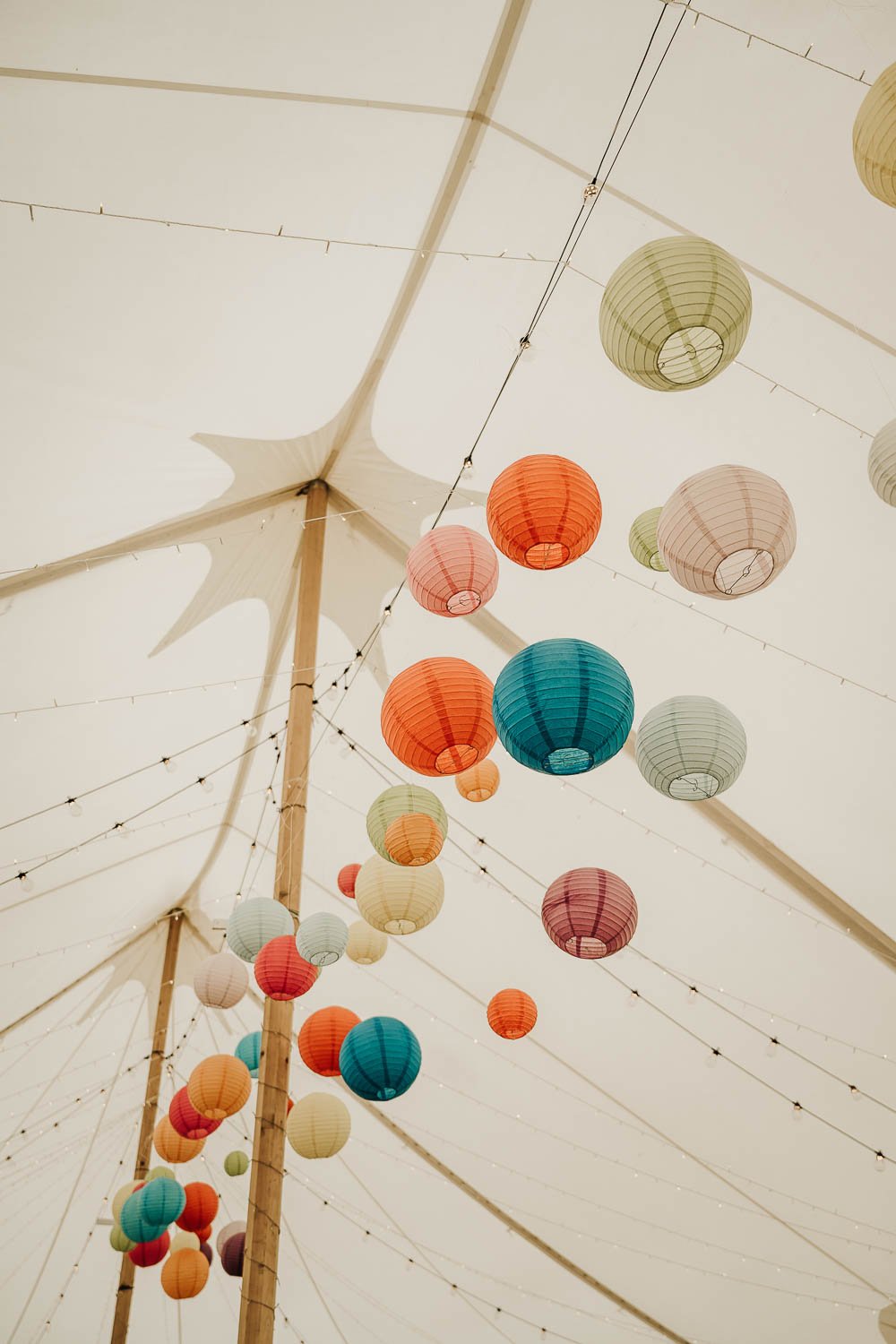 Colourful lanterns in the pitch of the wedding marque