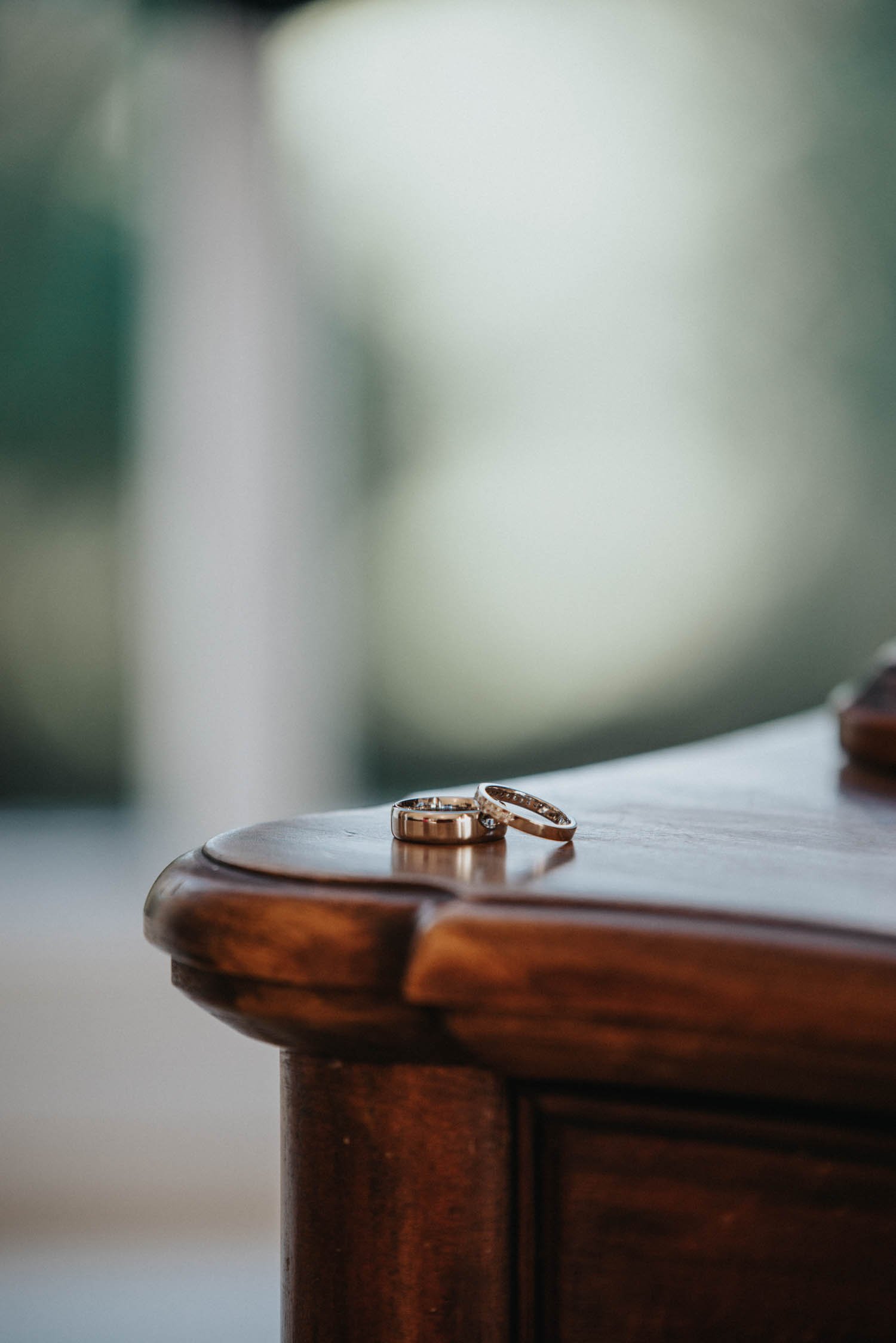 Wedding bands on corner of table with blurred background