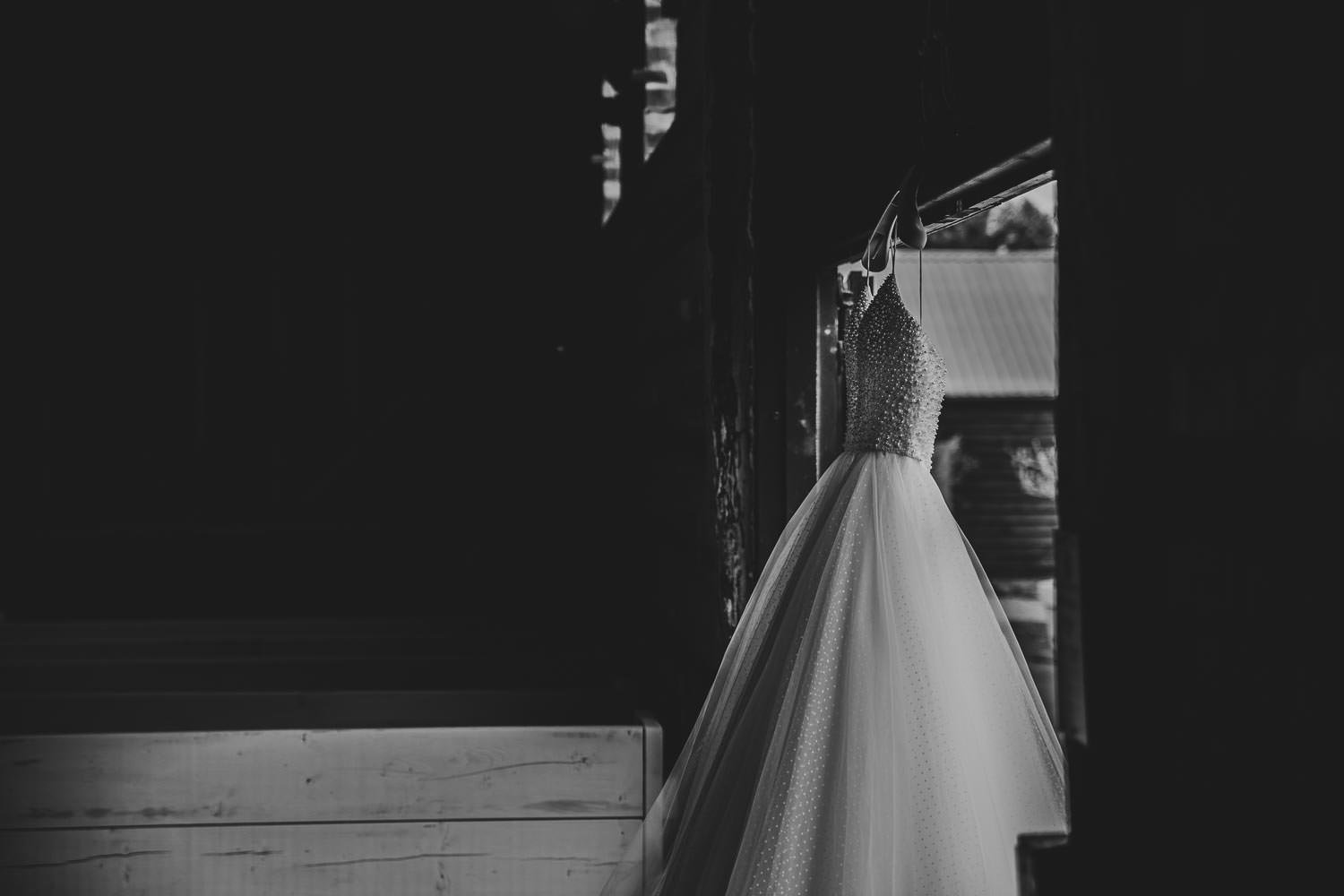 Wedding dress hanging on display in the Oak Barn at Milling Barn in Throcking in the 