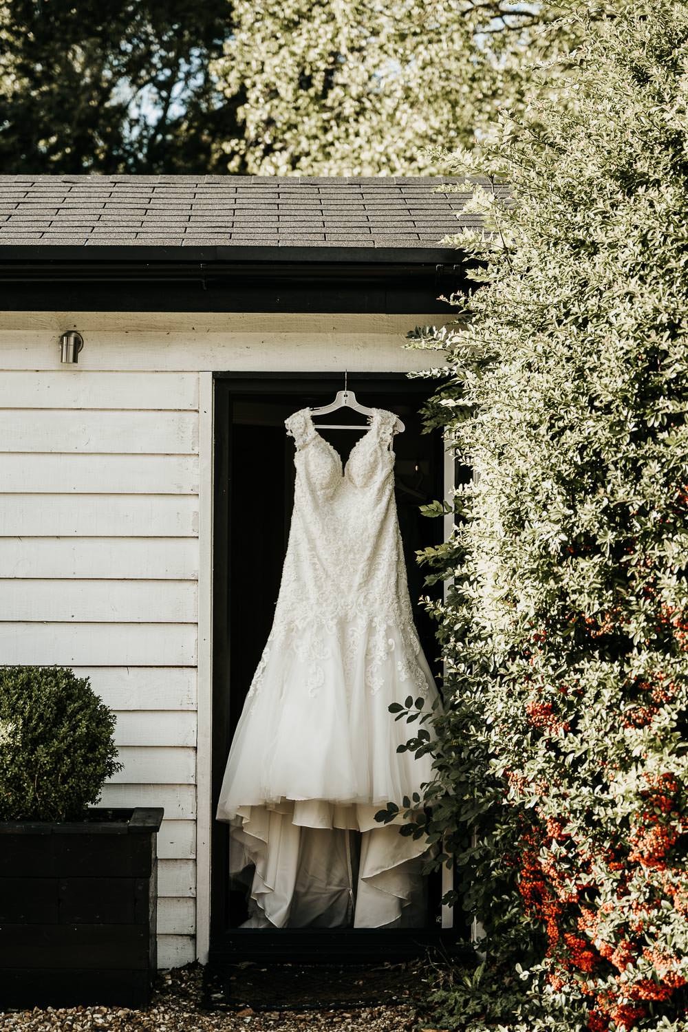 Bridal gown hanging in doorway of bridal suite at Sheene Mill