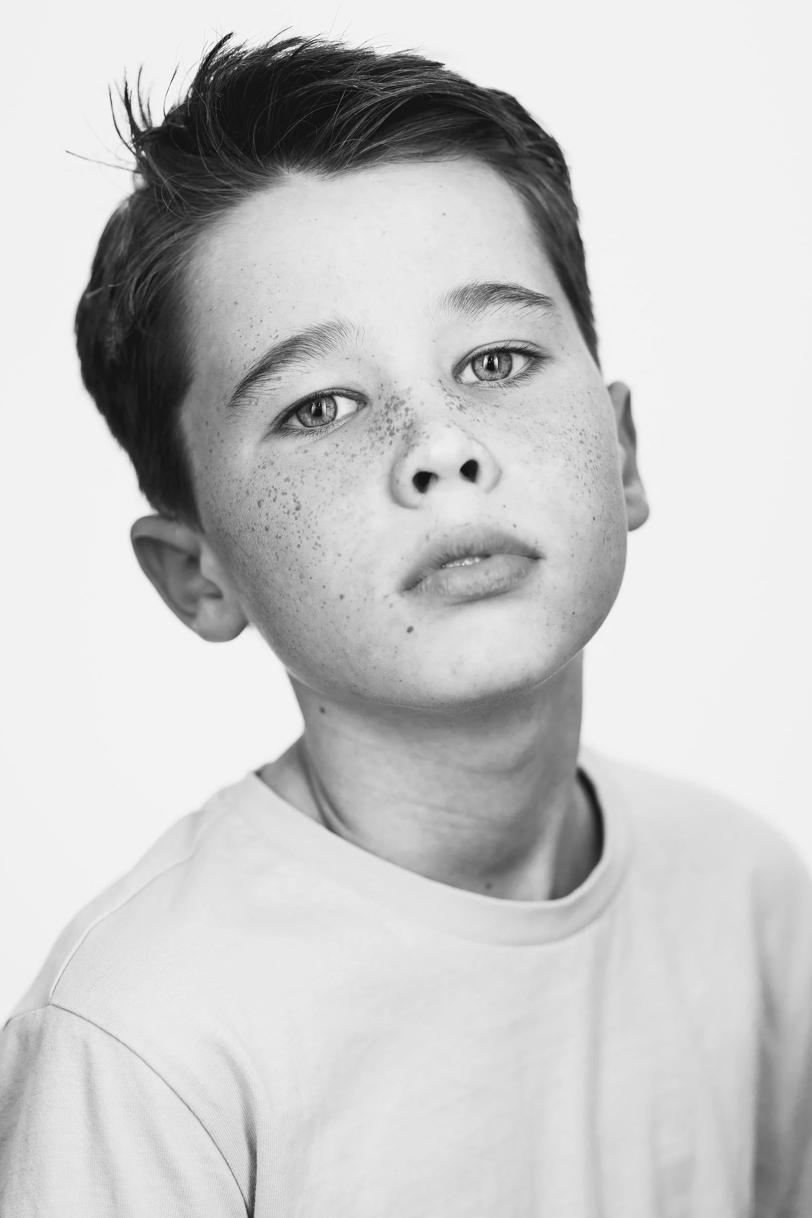 Fine art black and white studio portrait of a boy, child photography Hertfordshire