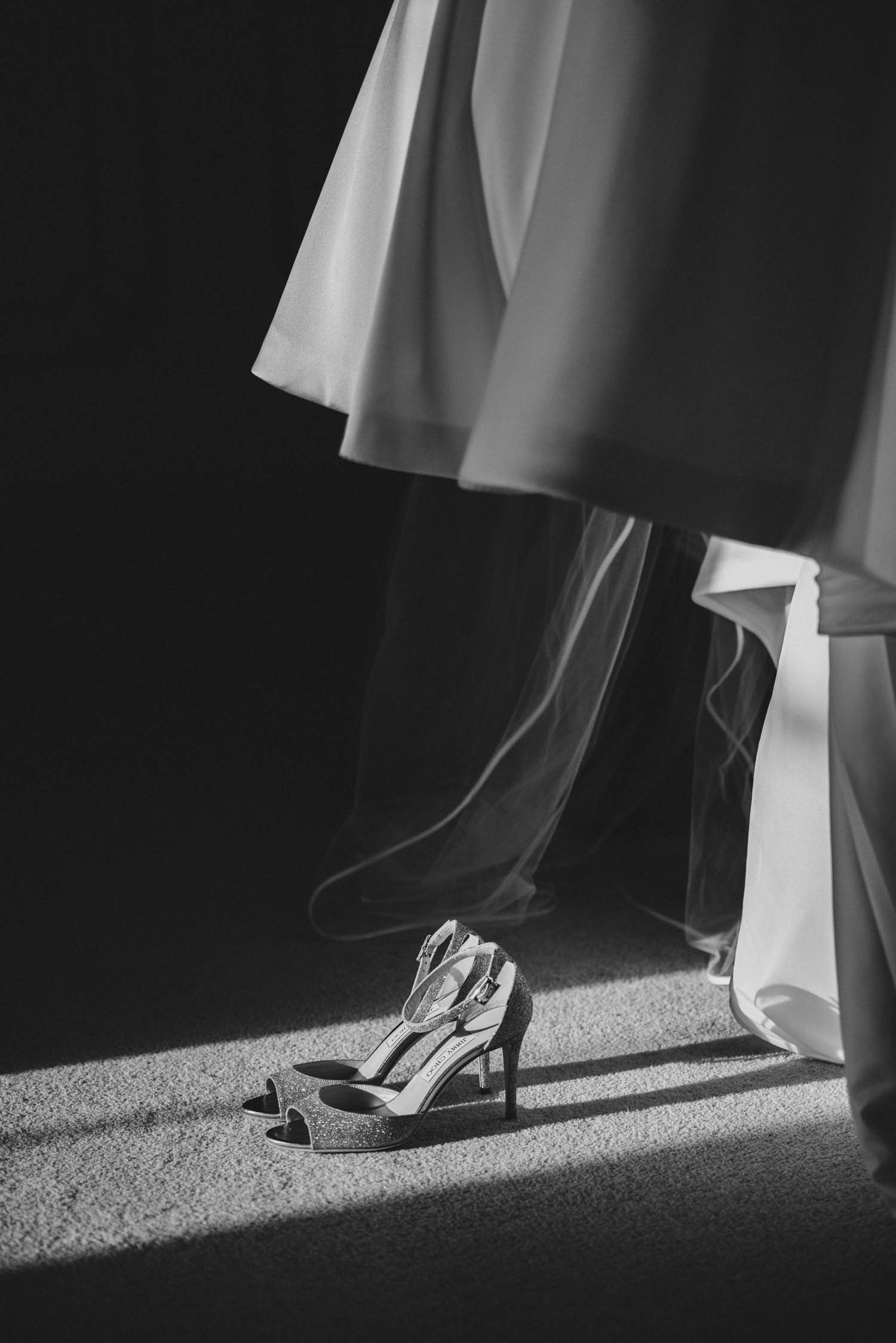 Jimmy Choo wedding shoes in black and white with streaking sunlight