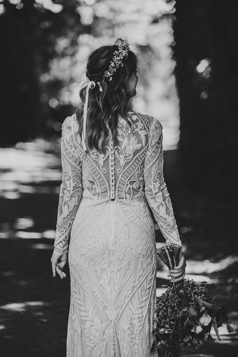 Bride wearing lace dress and crown of flowers