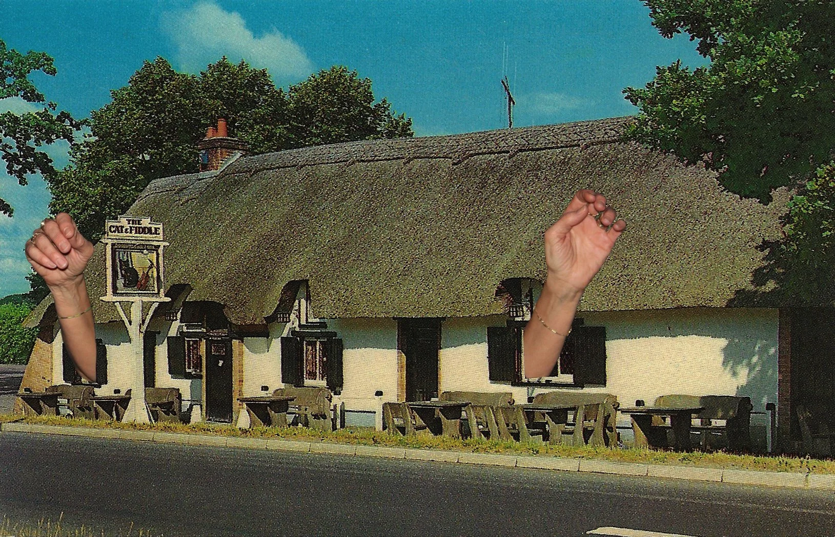 Untitled, 2024, Photo Collage

Image Description: A thatched-roof pub named "The Cat & Fiddle" with two human hands superimposed on the building, set among trees and clear sky.
