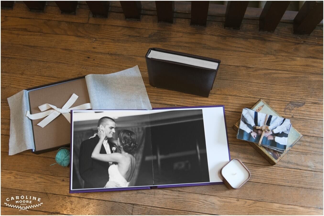 an assortment of printed products - small photos and albums - on a wood floor
