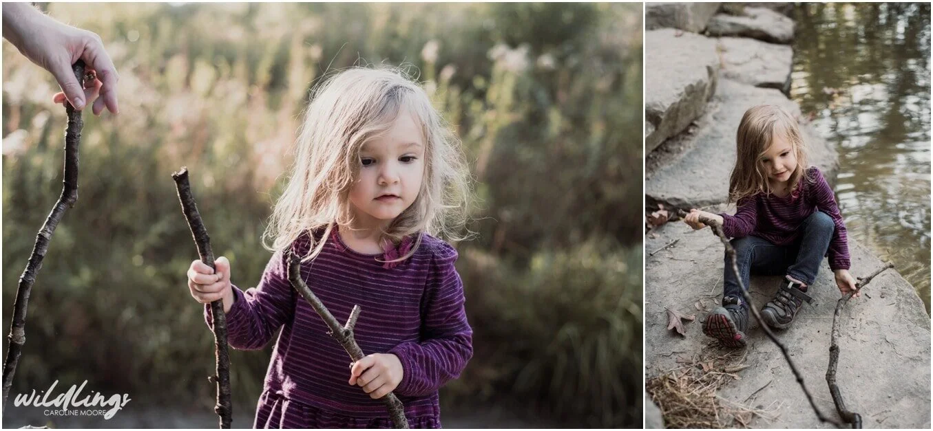 A toddler walks with two sticks at Beechwood Nature Preserve in Pittsburgh