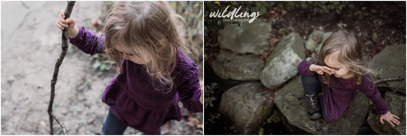 A toddler sits on a large flat rock, her face away from camera