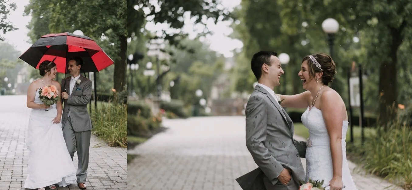 A couple laugh while standing in the rain in their wedding attire