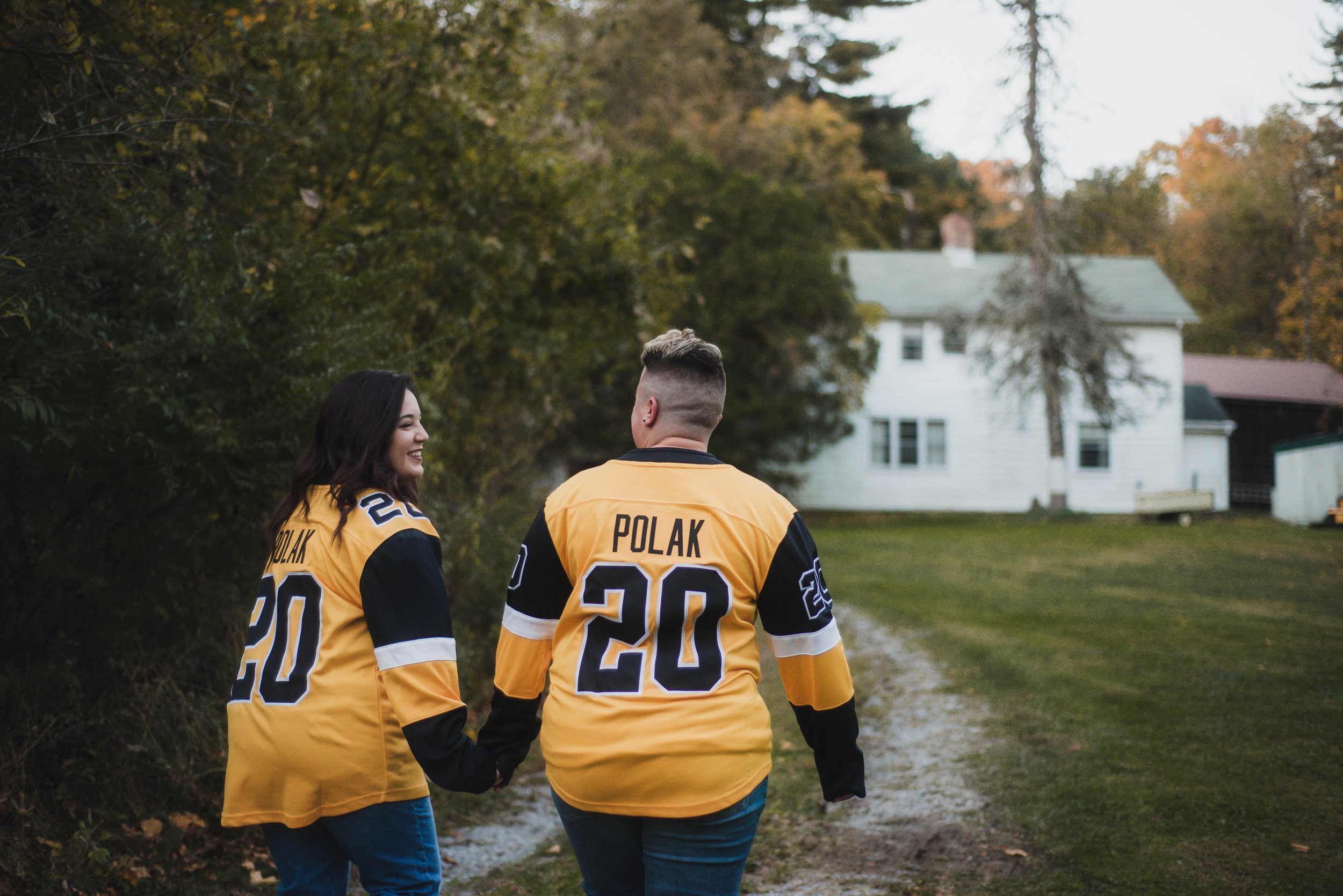 trans couple in matching hockey jerseys for their engagement session