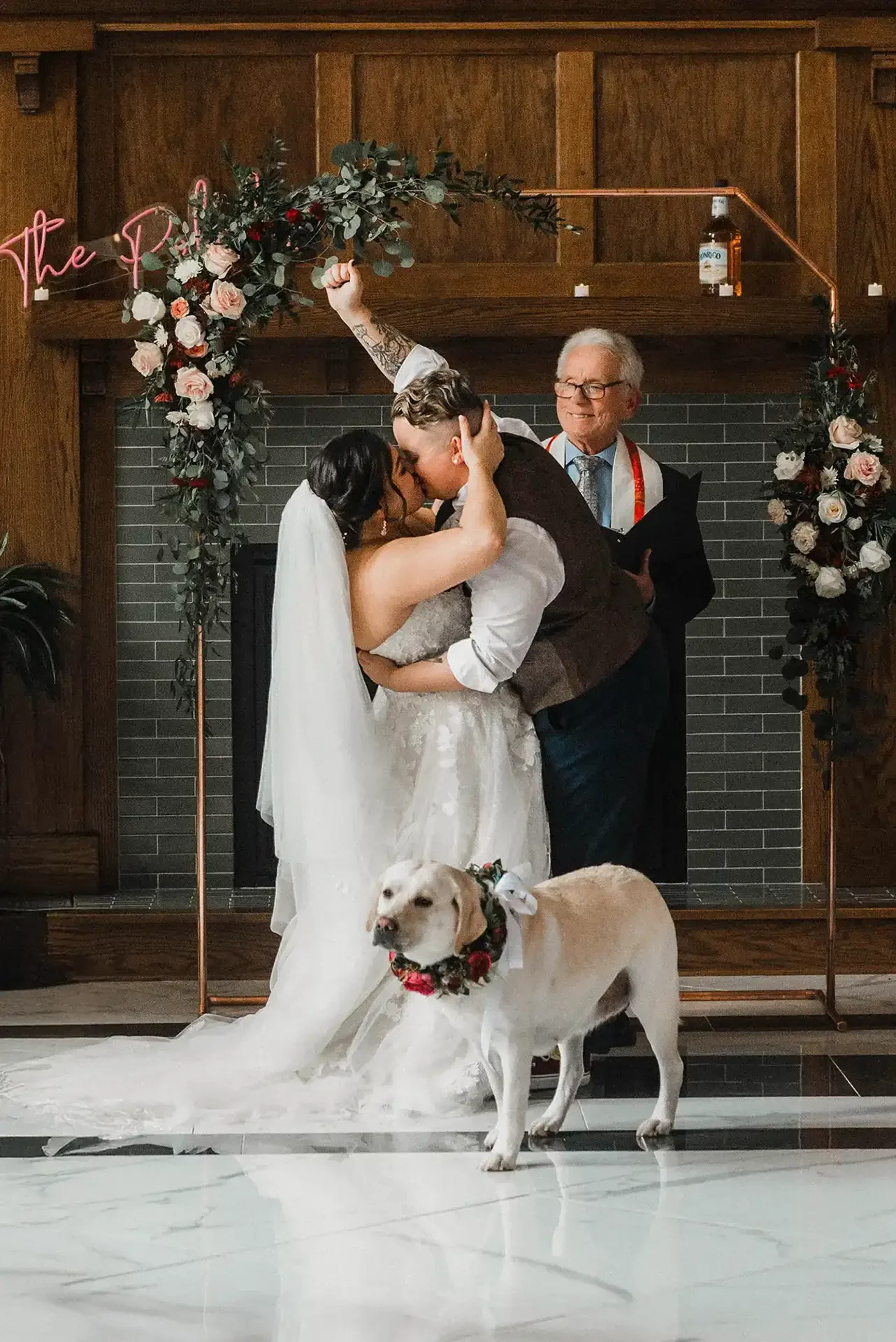 LGBTQ couple celebrate their elopement, along with their dog, who wears a flower wreath around her neck