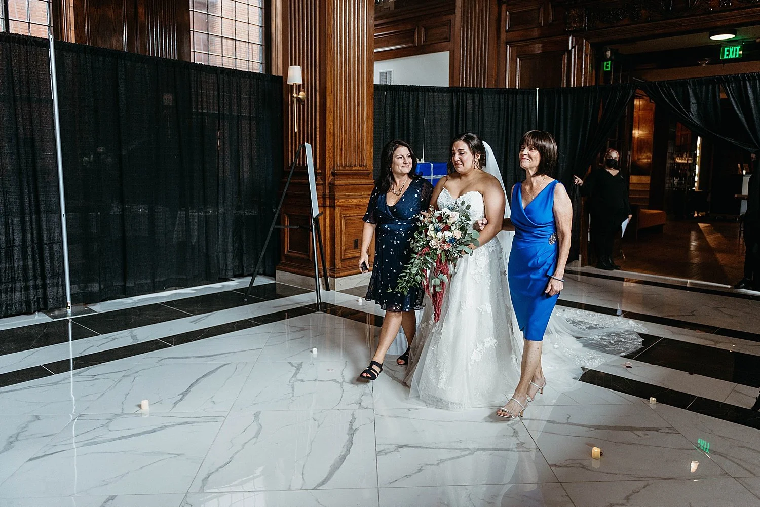 Bride walking down the aisle at Hotel Morgan, she also looks emotional.