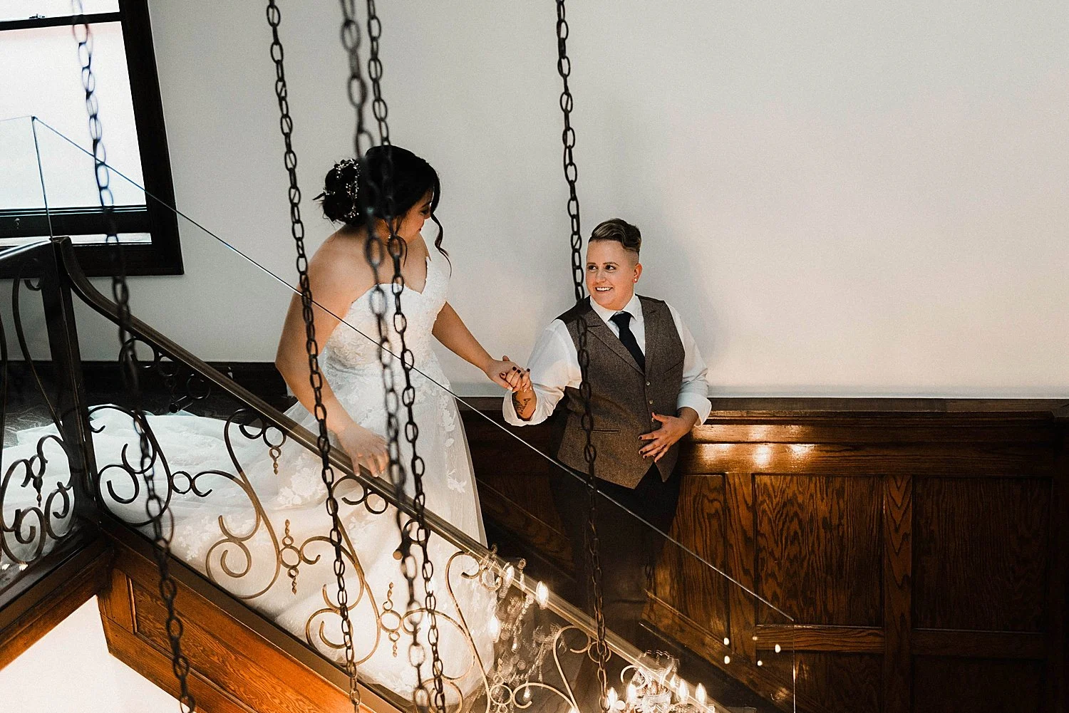 Queer couple pose on stairs for their west virginia wedding