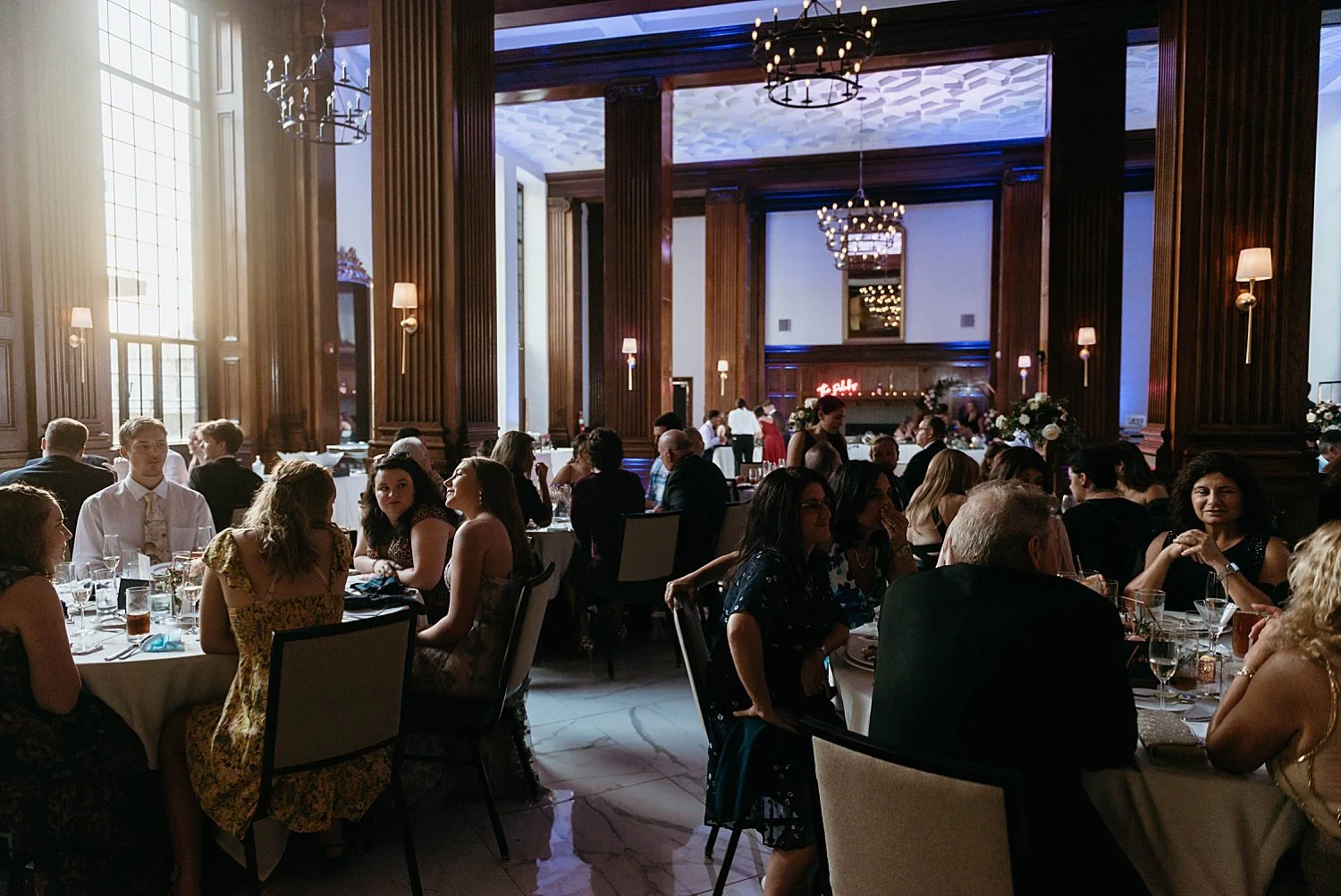 reception space at hotel morgan, you can see the late day sunlight  streaming into one side of the room while the other is lit by purple tinged artificial lighting