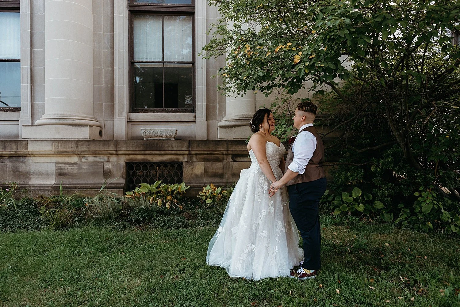 Bride and groom hold hands beneath a tree in west virginia