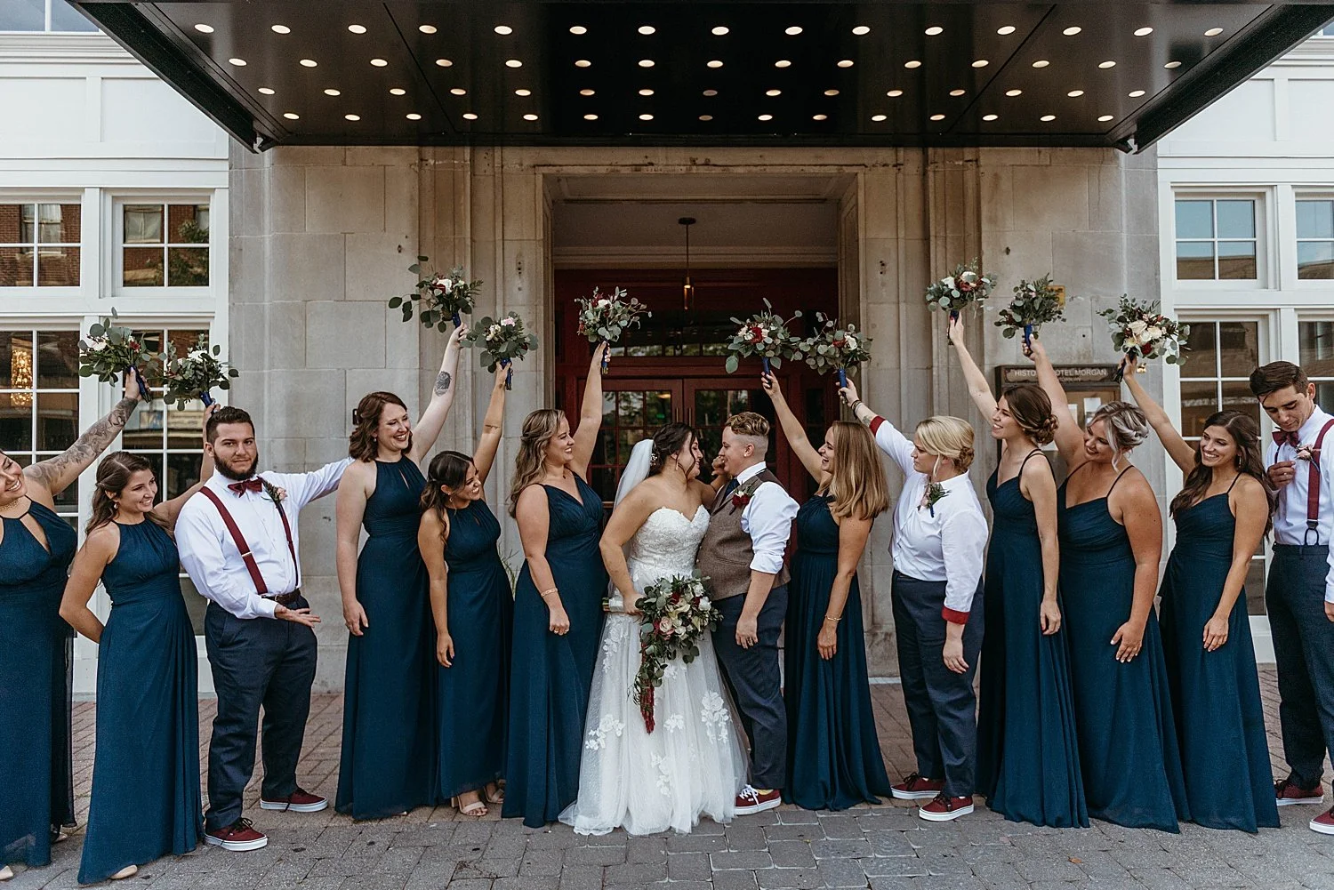 entire wedding party poses under the hotel morgan sign