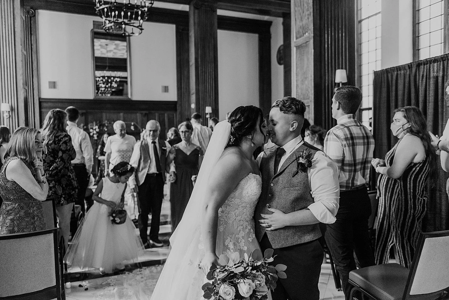 Bride and groom kiss at the end of their recessional