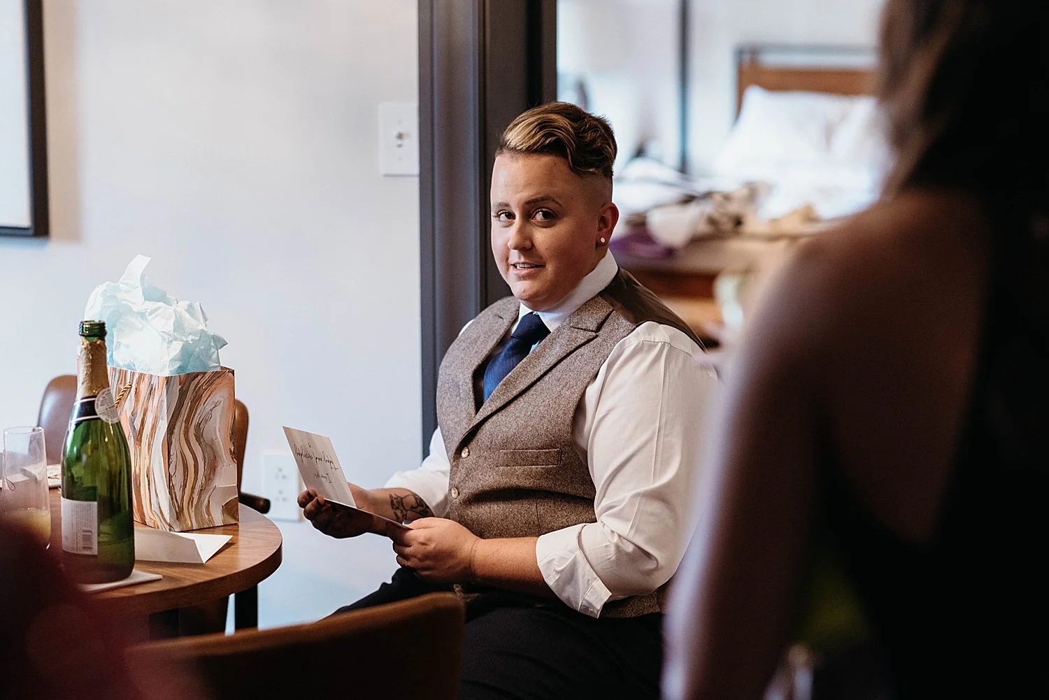 Trans groom opens letter from bride before wedding