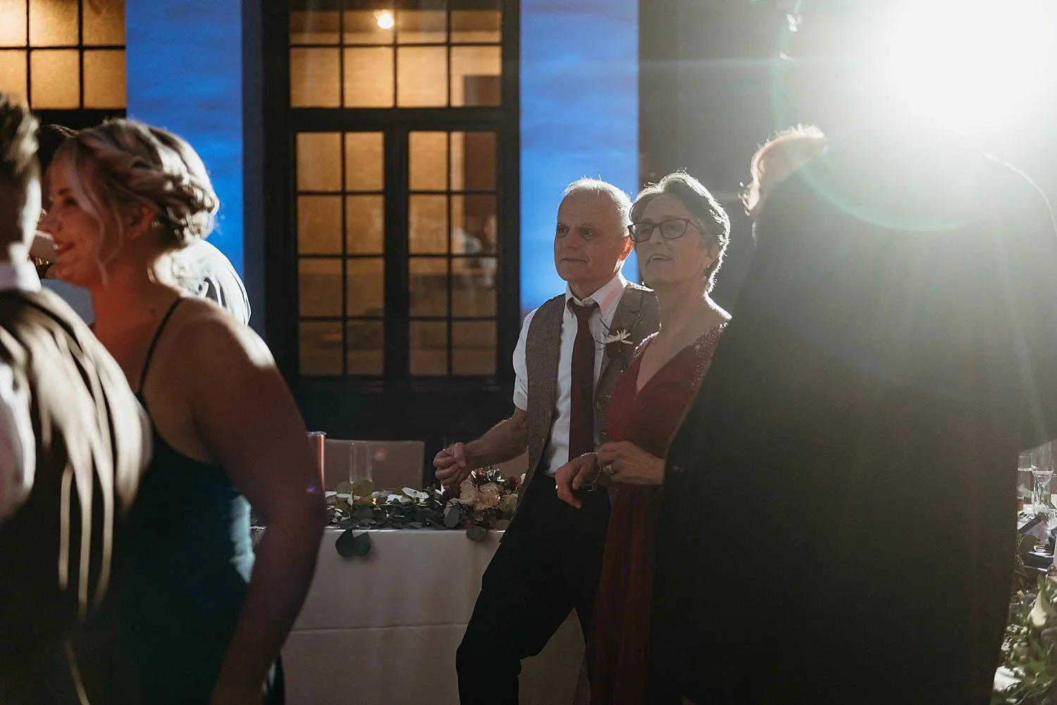 Groom's parents enjoying the reception, watching the dancing