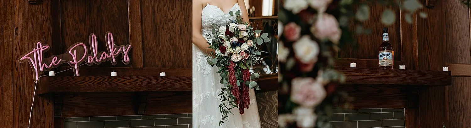 A neon sign that has the wedding couple's last name, and a photo of the bride's bouquet, a waterfall of greenery, and cream, pink, and red roses.