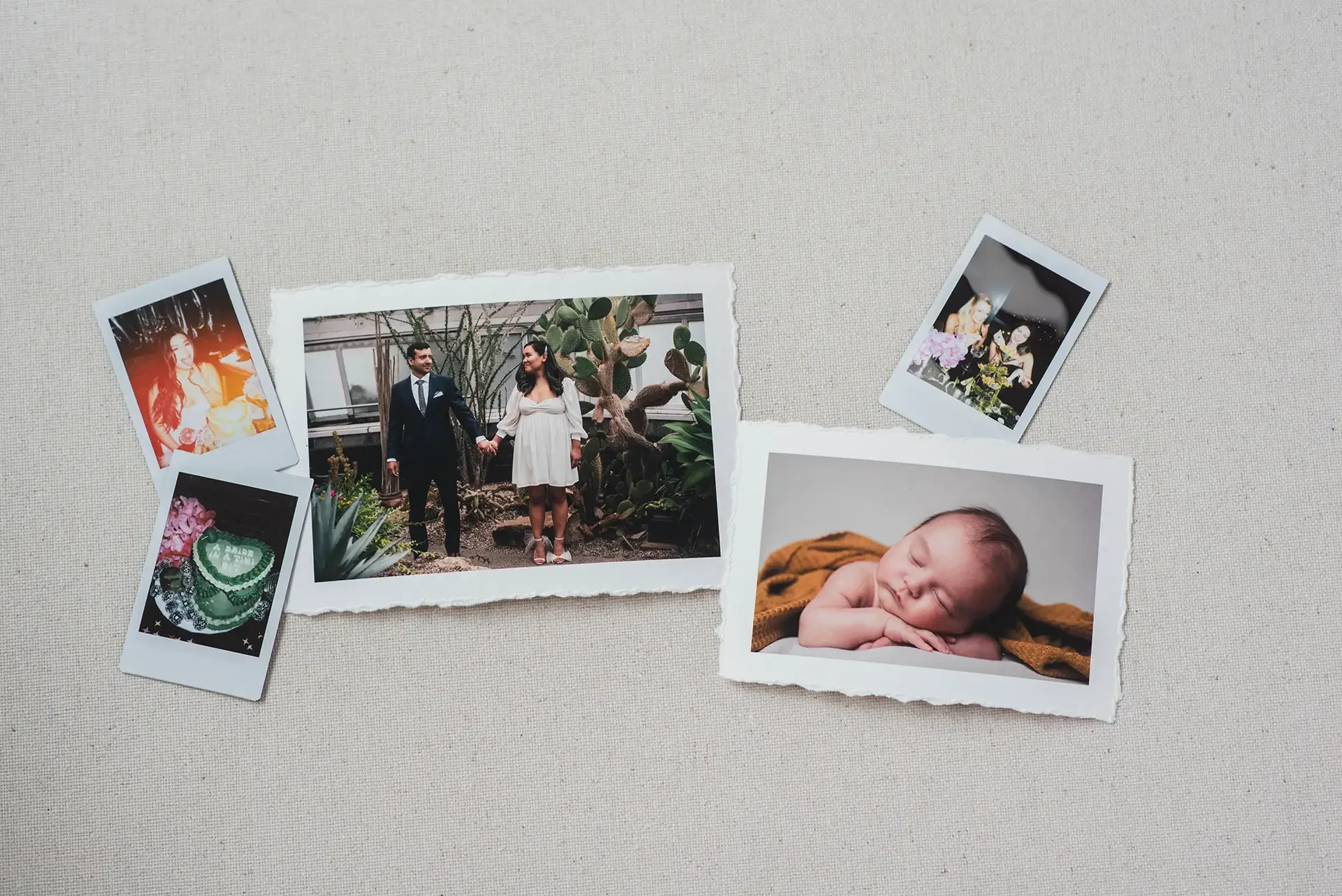 an assortment of printed photos, some on instant instax film and others with a deckled edge