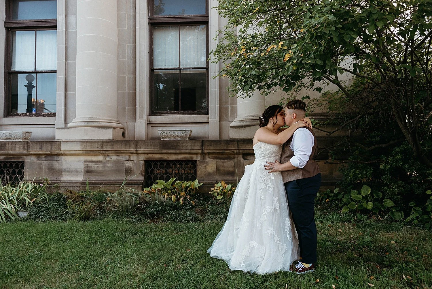 Bride and groom kiss beneath a tree at their morgantown wedding