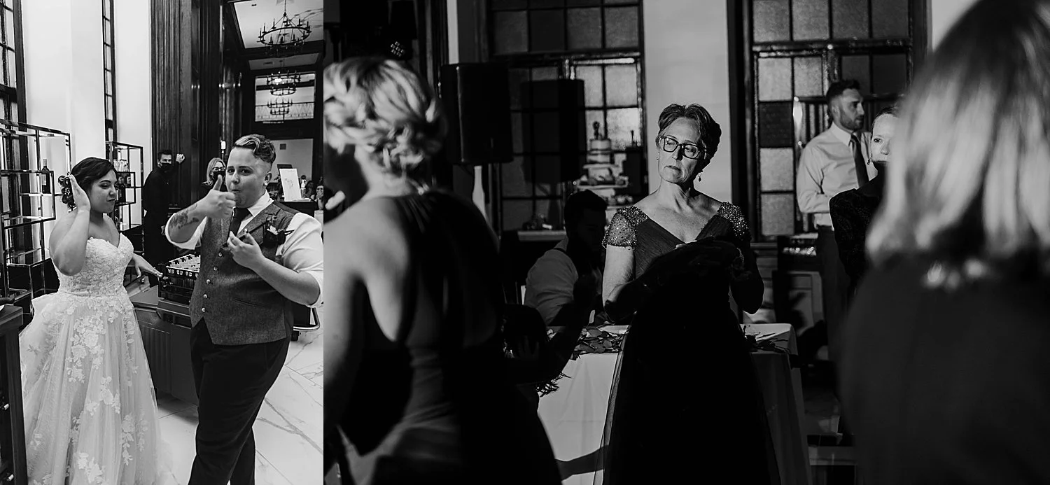 black and white photo of the bride and groom giving a thumbs up after eating their cake