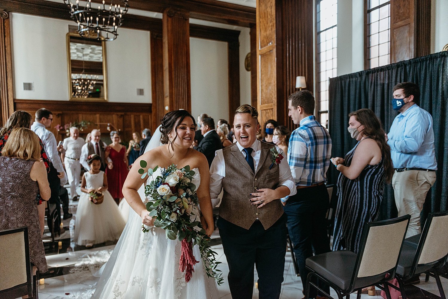 Bride and groom walk out of the ceremony at their hotel morgan wedding, they are talking to each other