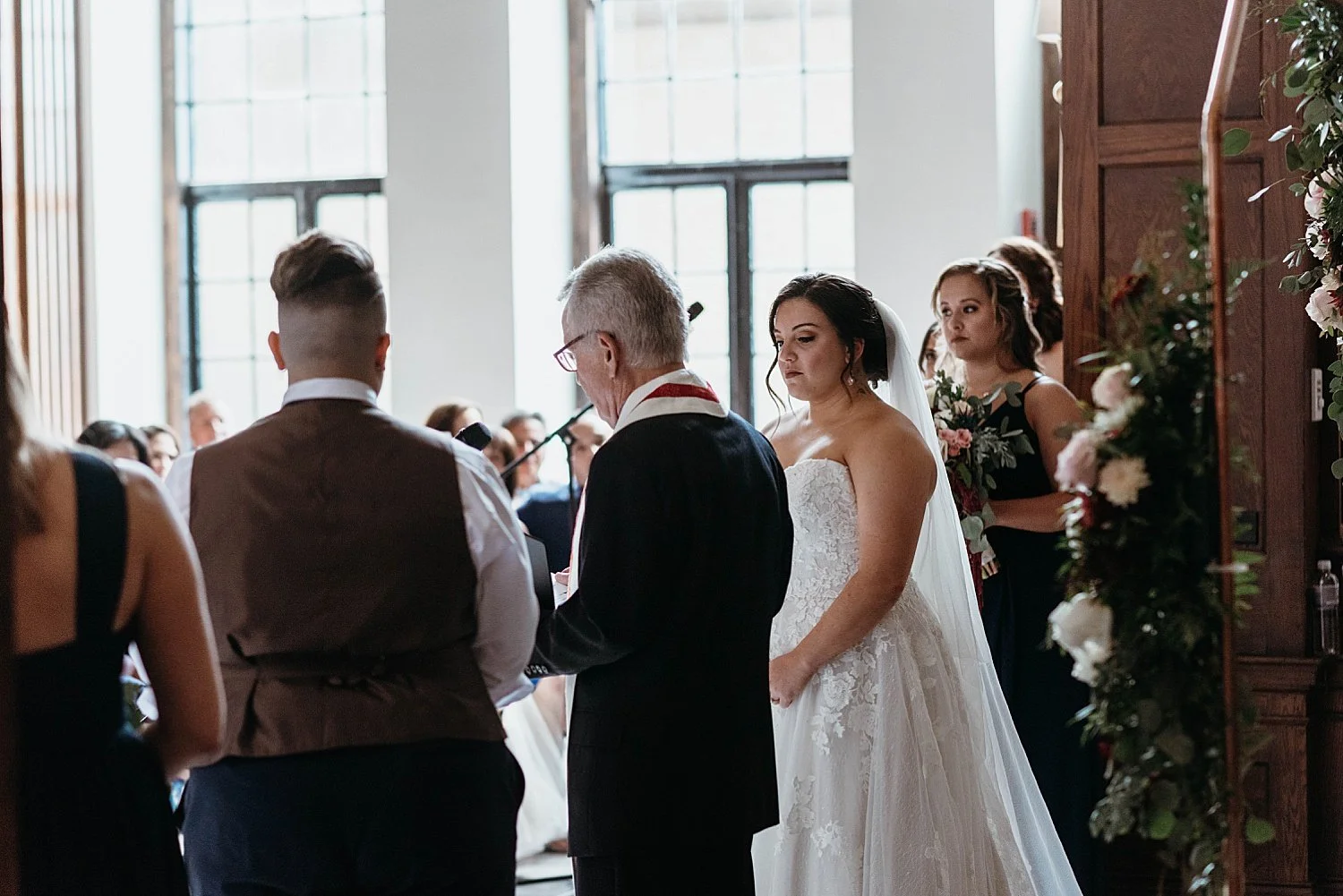 The bride listens to the officiant at her wedding