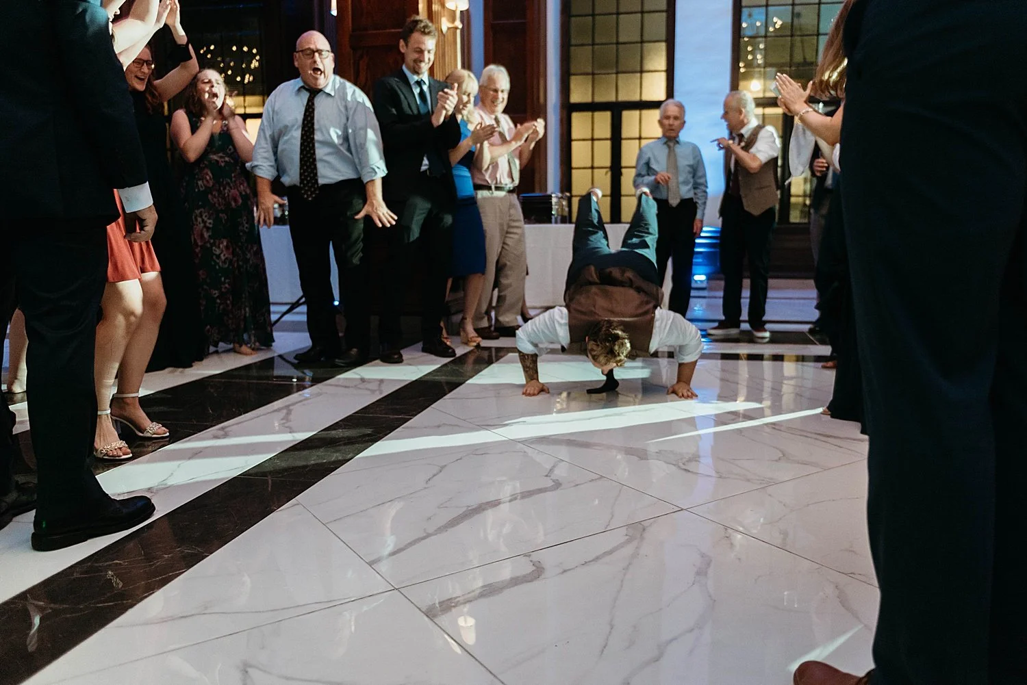 Groom does the worm on the marble floor at hotel morgan