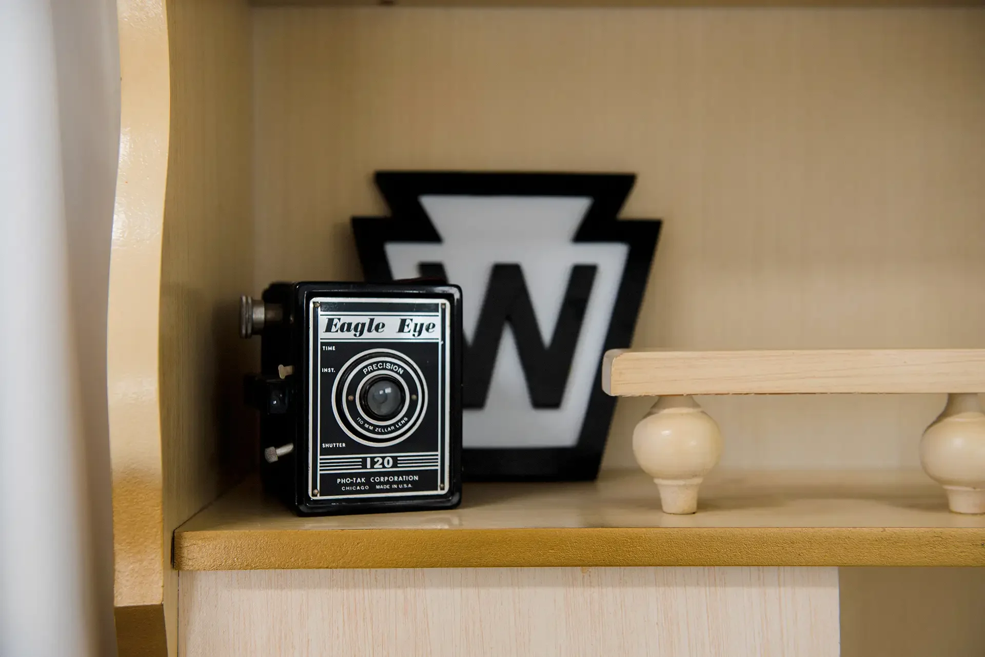 a vintage camera and a whistle stop sign