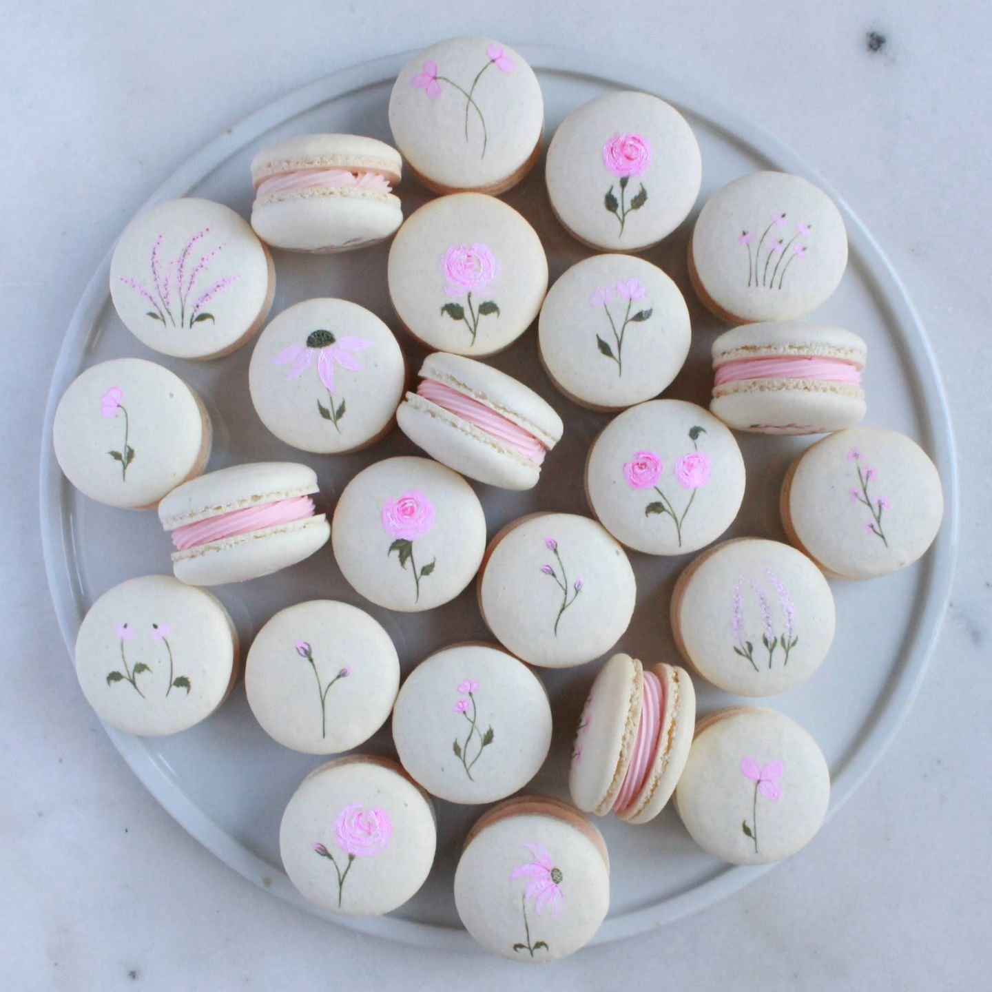 Pink flower macarons for the sweetest Sip &amp; See 💕🌸🌷

Filling flavors: vanilla buttercream and cookies &amp; cream

#karinasconfectioneries #orlandocookies #orlandomacarons #orlandofoodies #orlandocakedecorator #orlandosmallbusinesses