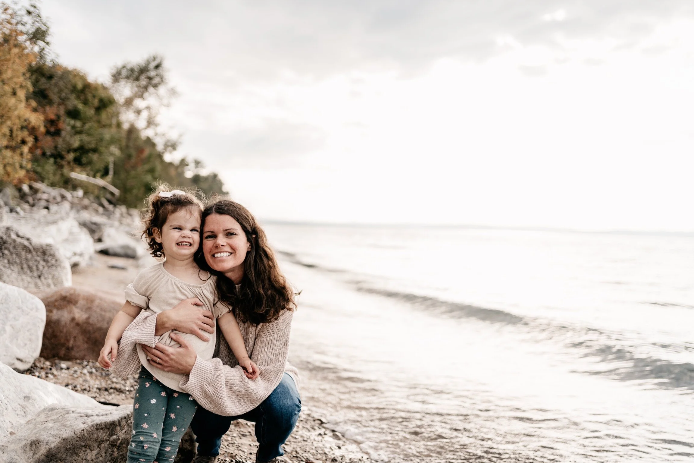 mother with daughter on beach on fall day