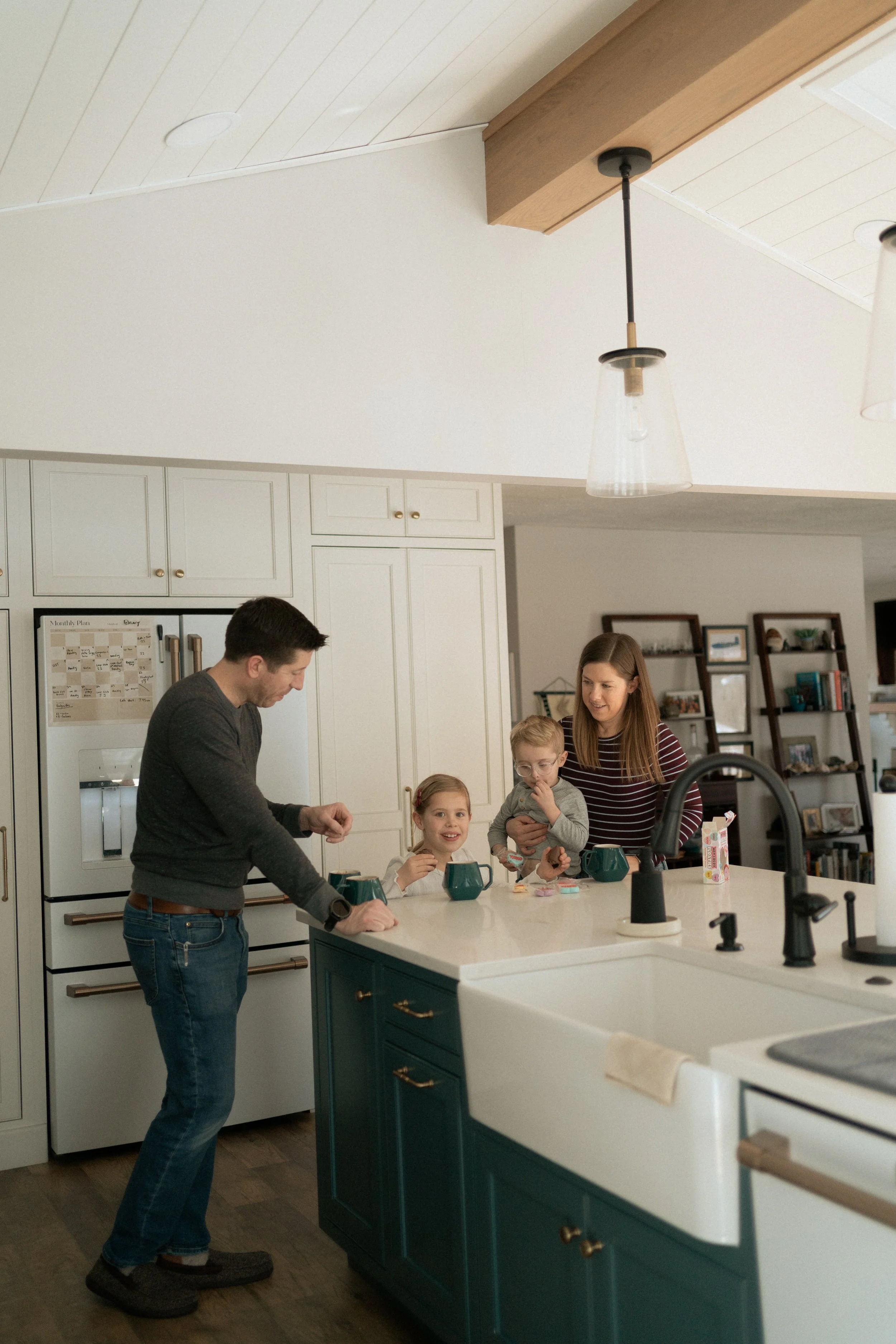 Family of four in kitchen making hot chocolate