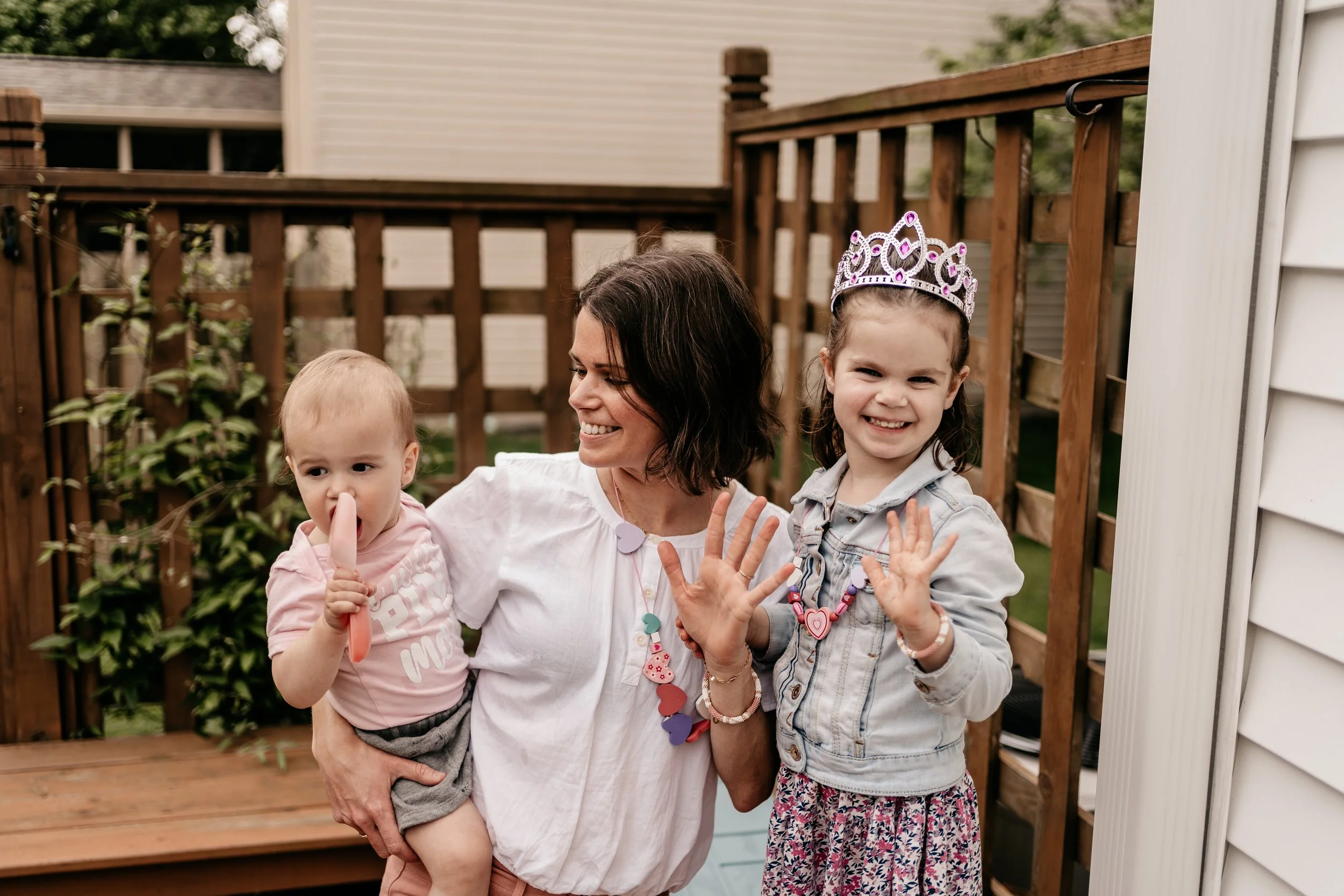 mother with breast cancer with young daughter and holding baby son, holding up five fingers for finishing fifth chemo treatment