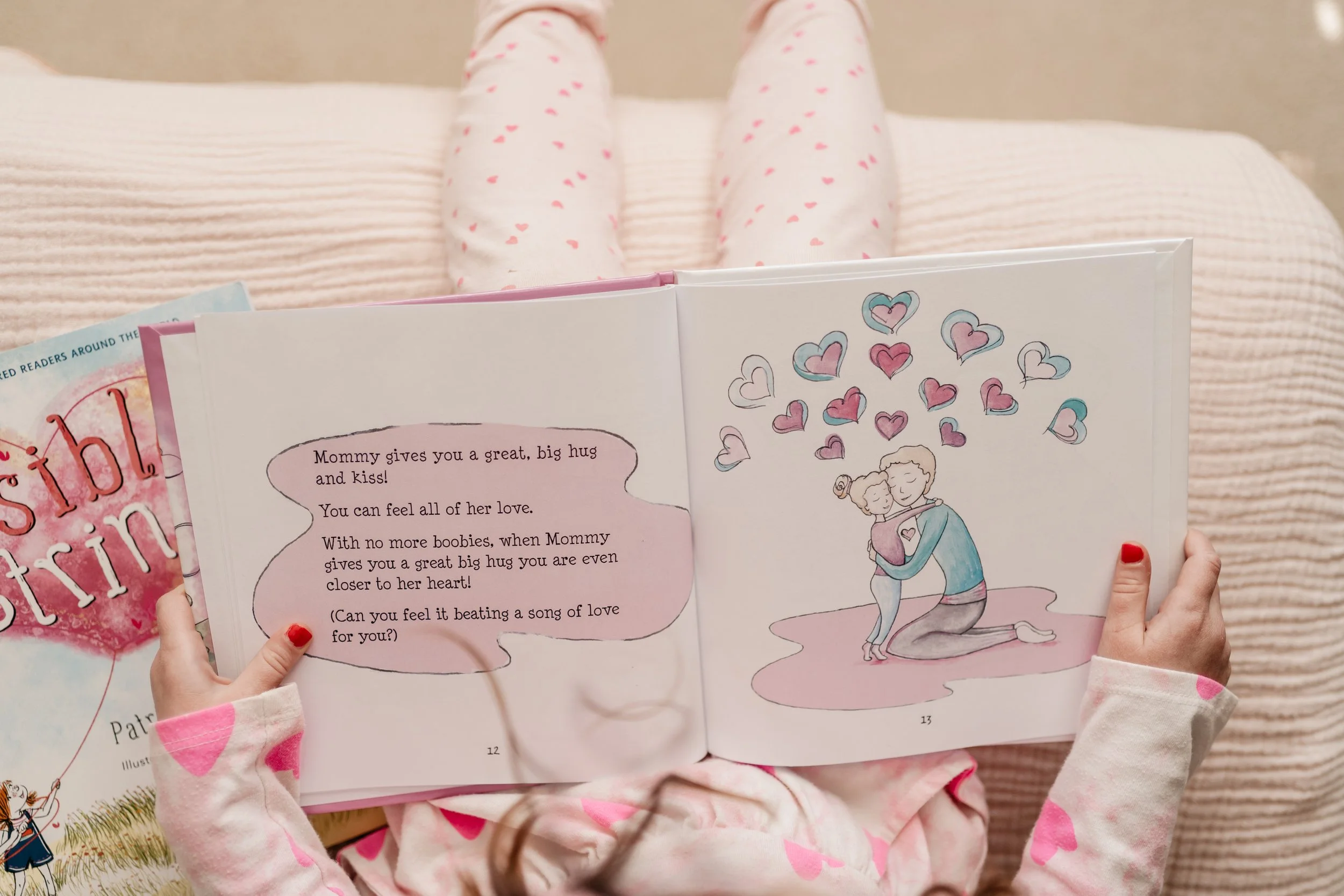 daughter holding book open about mother having breast cancer